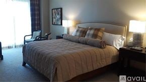 Longboat Key apartment for rent - A bedroom with a large bed and a chair.