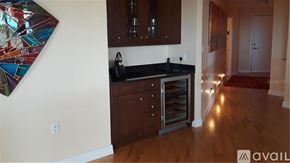 Longboat Key apartment for rent - A kitchen with dark wood cabinets and a black countertop.