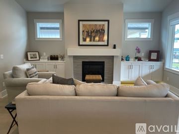 Bend house for rent - A living room with a fireplace and a large painting above it.
