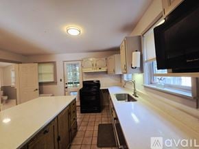 Memphis house for rent - A living room with a fireplace and a ceiling fan.