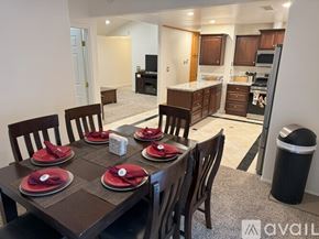 Santa Clarita house for rent - A dining room with a table set for six with red napkins.