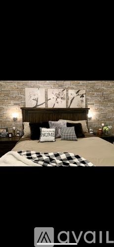 Miami house for rent - A bedroom with a brick wall and a bed with a checkered blanket.