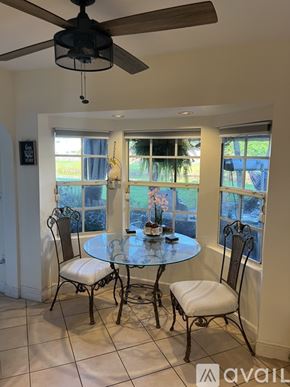 Miami house for rent - A dining room with a table and chairs.