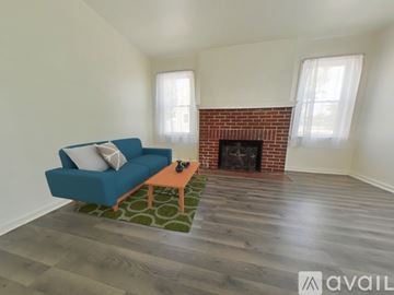 Lima house for rent - A blue couch sits in a living room with a brick fireplace.