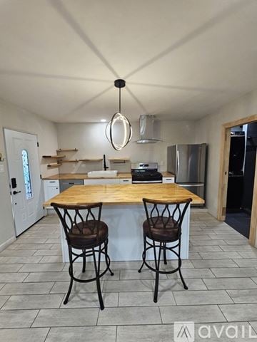 Santa Fe apartment for rent - A kitchen with a wooden table and two chairs.