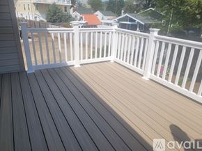 Virginia Beach condo for rent - A deck with white railings and a shadow of a person on the floor.