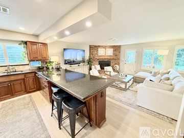 Bakersfield house for rent - A kitchen with a bar stool and a countertop.