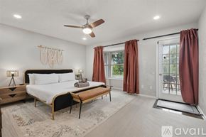 Garland house for rent - A bedroom with a large bed and a ceiling fan.