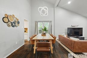 Garland house for rent - A modern dining room with a wooden table and chairs.