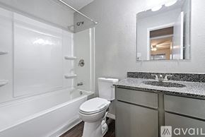 Sulphur Springs apartment for rent - A bathroom with a white toilet and a white bathtub.