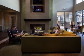 Denton apartment for rent - a group of people sitting in a living room with laptops