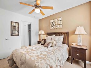 Mandeville apartment for rent - a bedroom with a bed and a ceiling fan