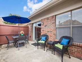Carrollton apartment for rent - a patio with a table and chairs and an umbrella