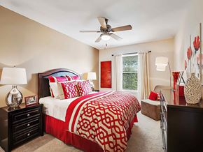Carrollton apartment for rent - a bedroom with a bed and a ceiling fan