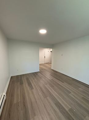 Dartmouth apartment for rent - A room with a wooden floor and a white wall.