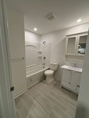 Dartmouth apartment for rent - A white bathroom with a toilet, sink, and bathtub.