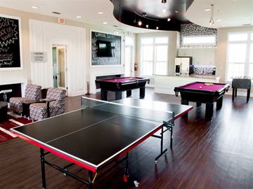 Starkville apartment for rent - a game room with two pool tables and a tv