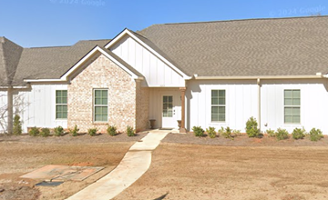 Auburn house for rent - A white house with a brown roof and a small garden in front.
