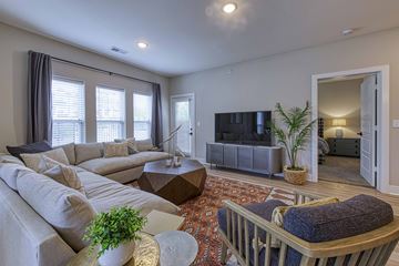 Belton apartment for rent - A living room with a grey couch and a wooden coffee table.