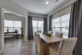 Belton apartment for rent - A dining room with a wooden table and striped chairs.