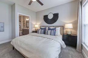 Belton apartment for rent - A bedroom with a large bed and a ceiling fan.
