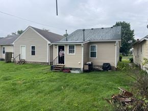 Louisville house for rent - A house with a grey roof and a couple standing in the doorway.