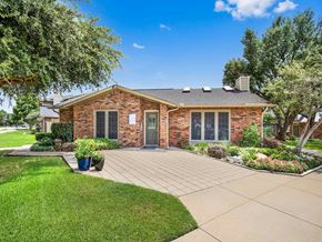 Carrollton apartment for rent - the front of a brick house with a driveway and grass