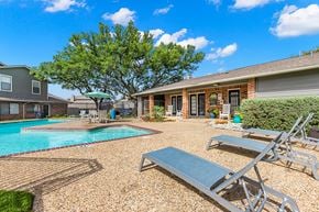Carrollton apartment for rent - A backyard with a pool and a patio area.