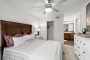 Carrollton apartment for rent - A bedroom with a large bed and a ceiling fan.