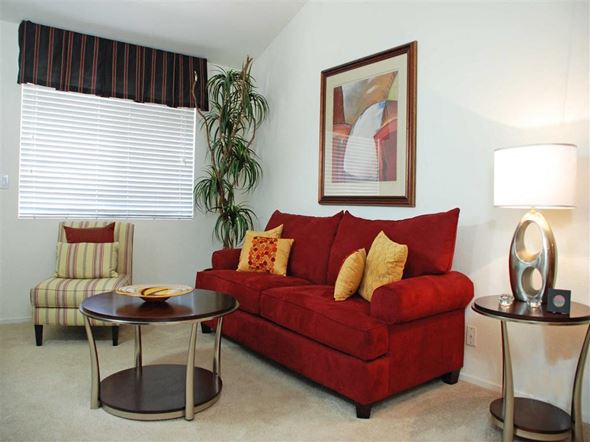 Chandler apartment for rent - a living room with a red couch and a table