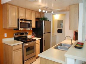 Chandler apartment for rent - a kitchen with stainless steel appliances and wooden cabinets