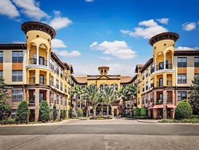 Tampa apartment for rent - a view of the exterior of an apartment building with palm trees