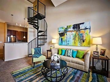 Tampa apartment for rent - a living room with a spiral staircase and a couch
