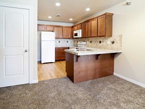Willison apartment for rent - a kitchen with wooden cabinets and a white refrigerator