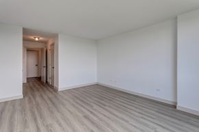 Edmonton apartment for rent - A room with a white wall and a wooden floor.