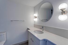 Edmonton apartment for rent - A bathroom with a sink, mirror, and lights.