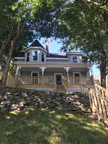 Bedford apartment for rent - A house with a stone wall in front.