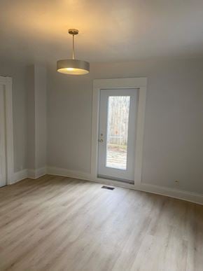 Bedford apartment for rent - A room with a door and a light hanging from the ceiling.