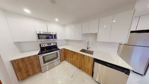 Wolfville apartment for rent - A modern kitchen with stainless steel appliances and wooden accents.