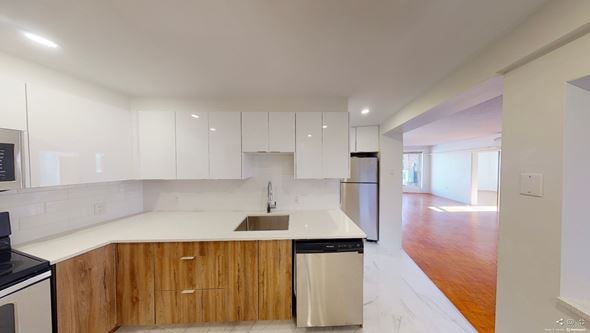 Wolfville apartment for rent - A modern kitchen with wooden cabinets and a white countertop.