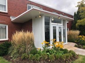 Wolfville apartment for rent - A red brick house with a white door and windows.