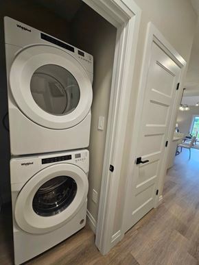 Corunna house for rent - Two white Whirlpool washing machines in a laundry room.