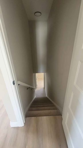 Corunna house for rent - A long hallway with a staircase on the left side.