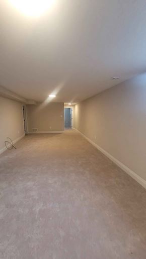 Corunna house for rent - A room with a white ceiling and walls, and a door on the right side.