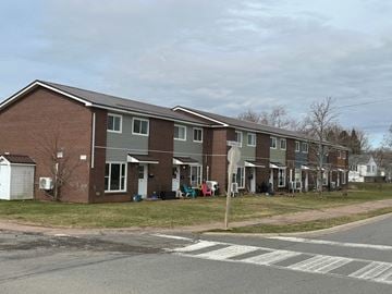 Amherst apartment for rent - A row of houses with a white sign in front of them.