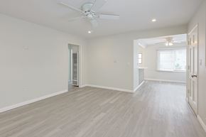 Coronado apartment for rent - A spacious room with a ceiling fan and lighting fixture.