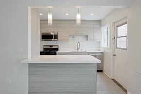 Coronado apartment for rent - A modern kitchen with a white countertop and a sink.