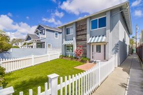 Coronado apartment for rent - A house with a white picket fence in front.