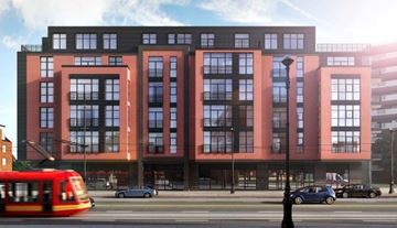 Washington apartment for rent - A red and black building with a tram in front.