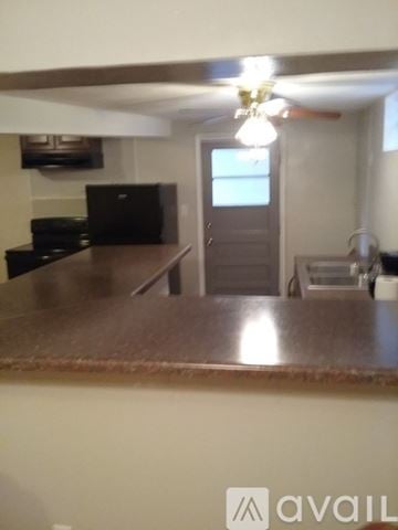 Roanoke house for rent - A kitchen with a brown counter top and a black fridge.